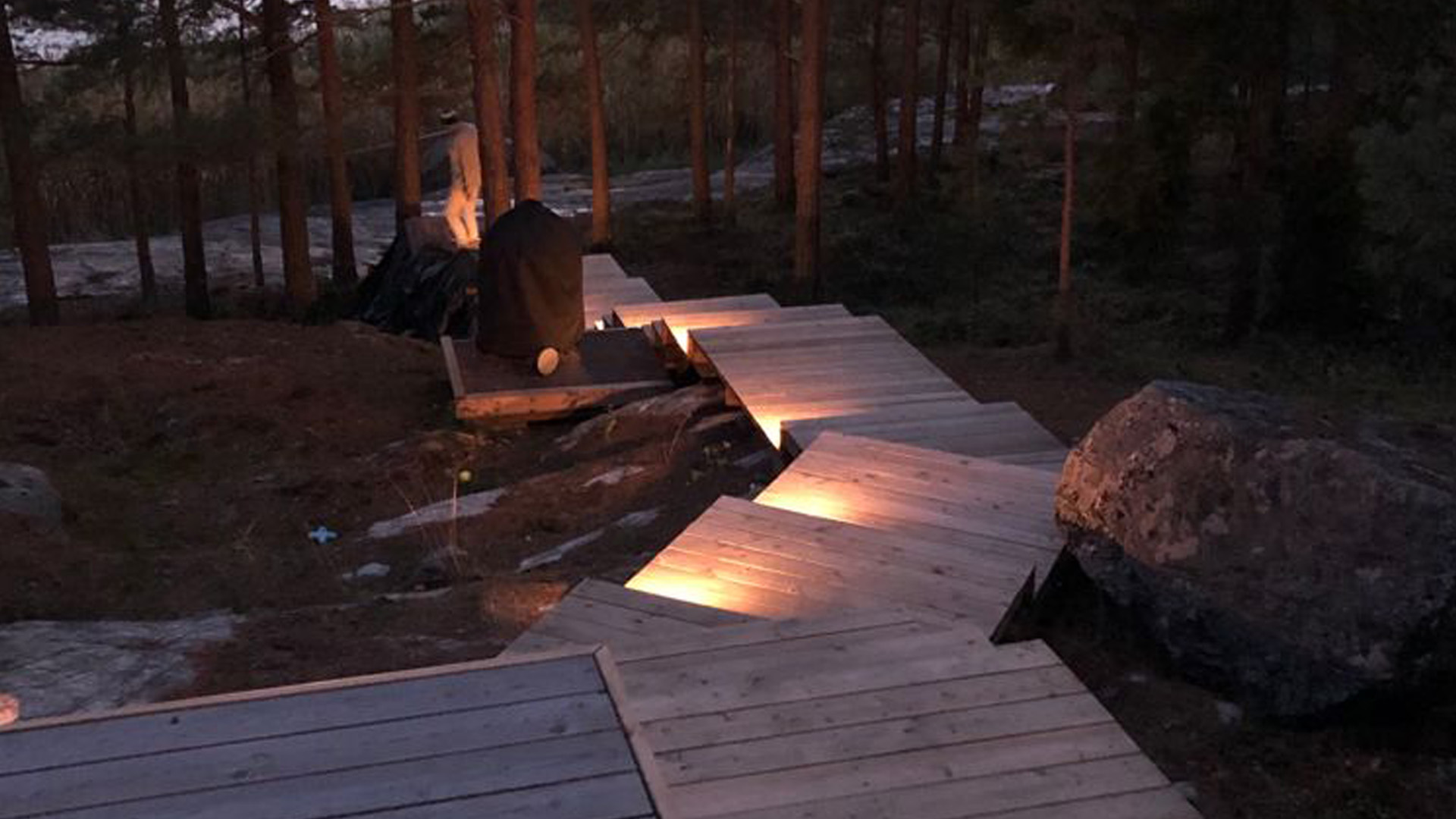 Terrace step lighting with spotlights mounted on the riser.
